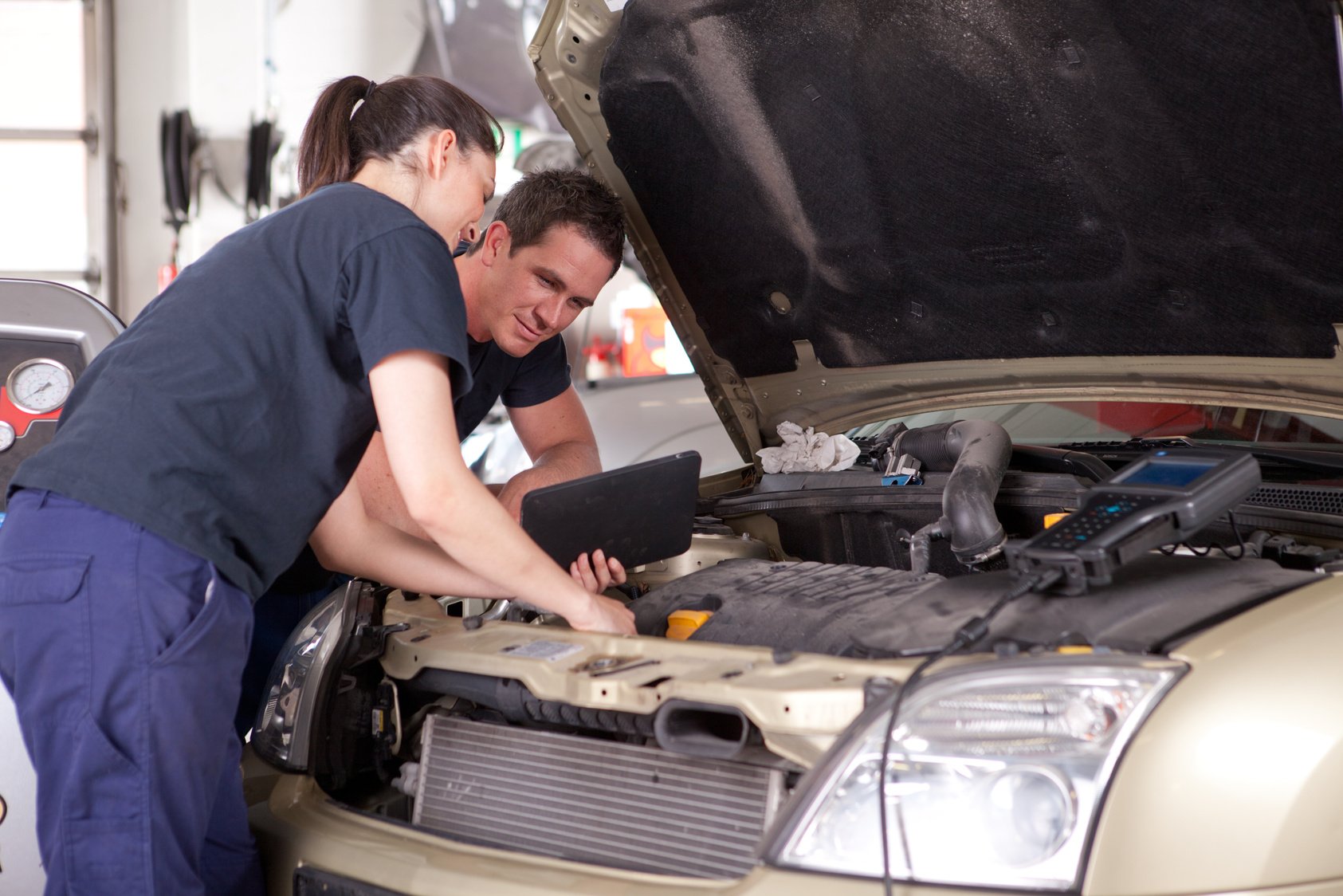 Woman Tuning Car with Diagnostic Equipment